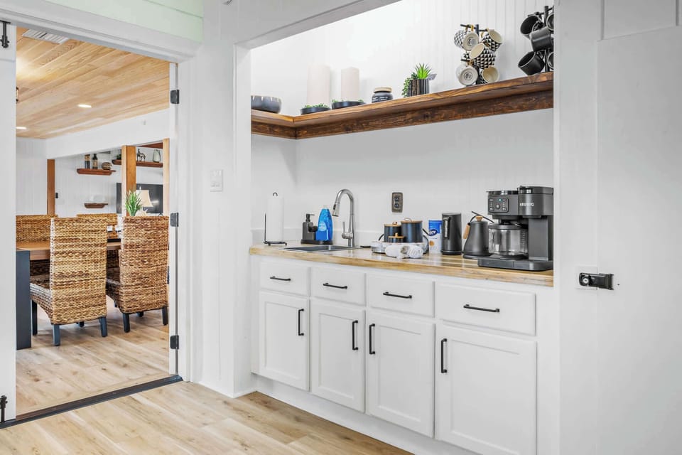 Compact kitchenette with coffee station and open access to the dining area
