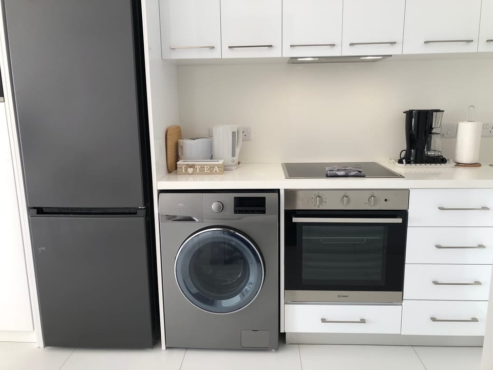Kitchen with washer, fridge and dryer