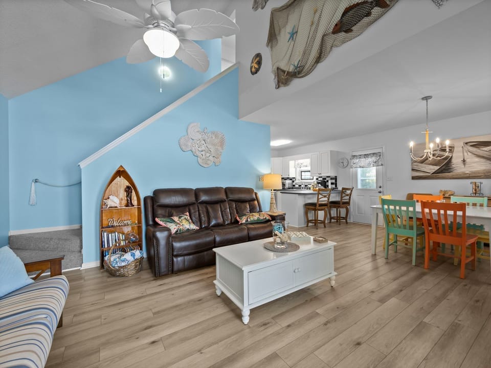 Relax in your bright coastal living space with leather seating, nautical touches, and an open layout connecting to your kitchen.