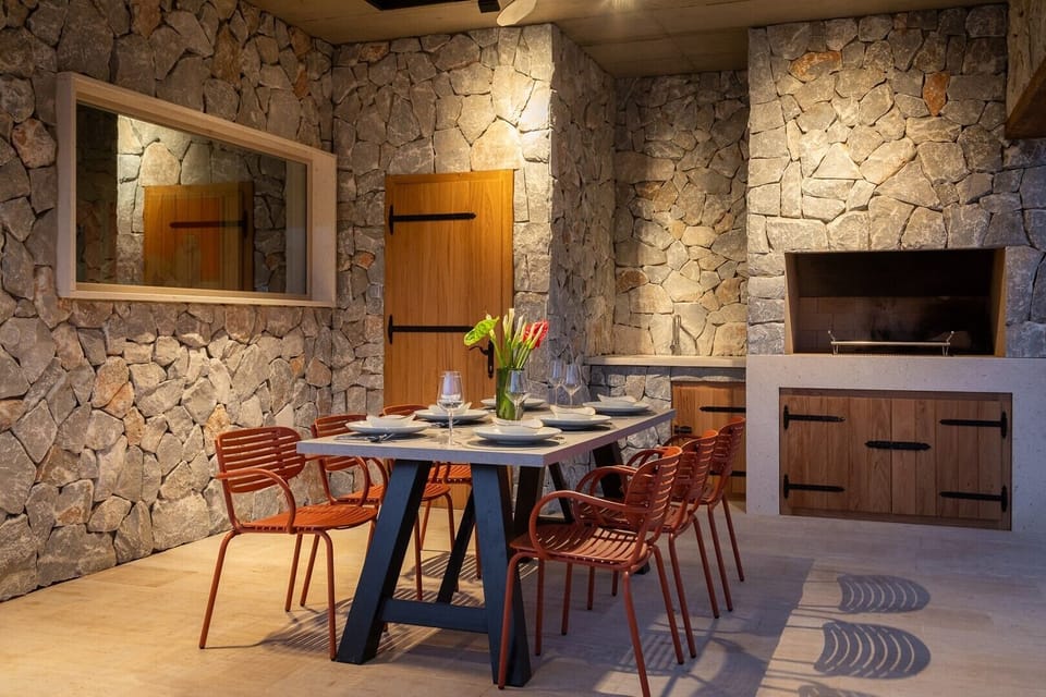 There is a covered outdoor dining area with a barbecue

