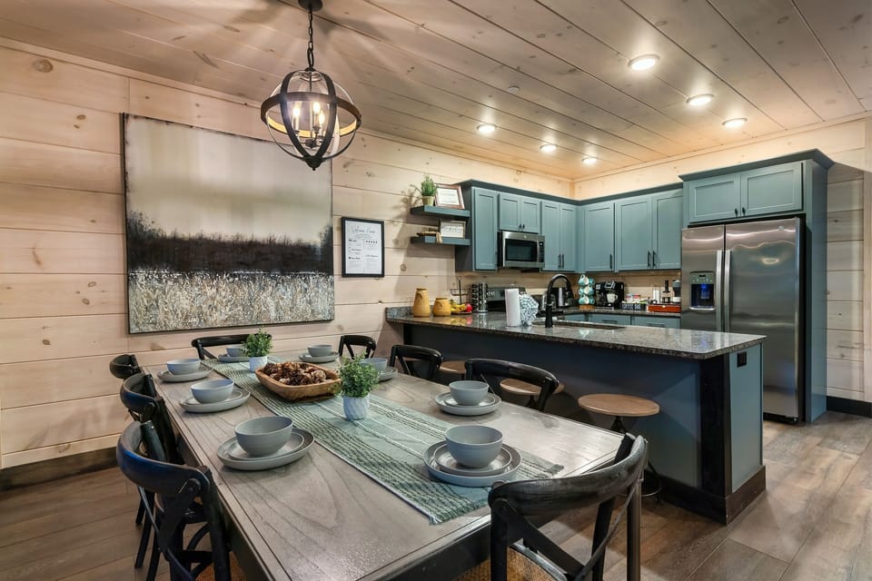 Dining area with seating for 8 at the table and 4 at the bar.