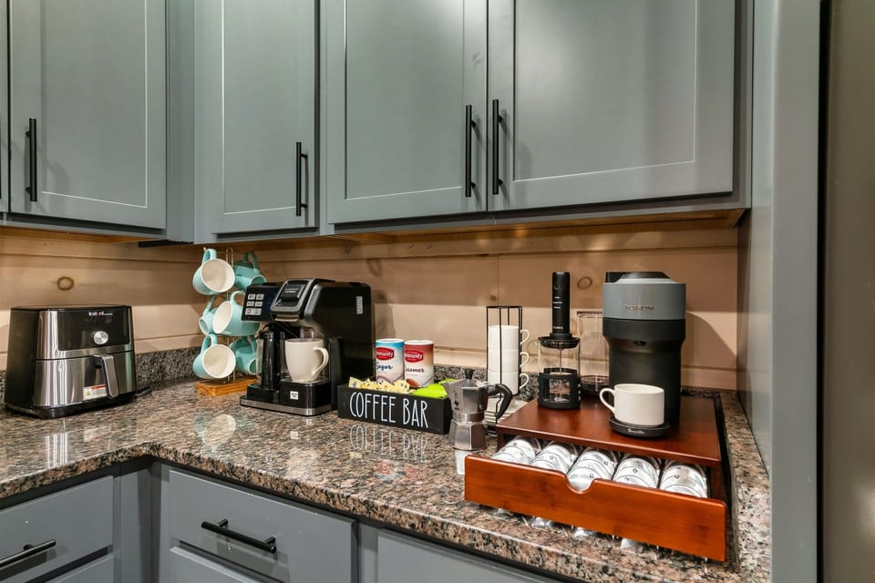 Coffee bar stocked with Nespresso capsules, sugar, and creamer.