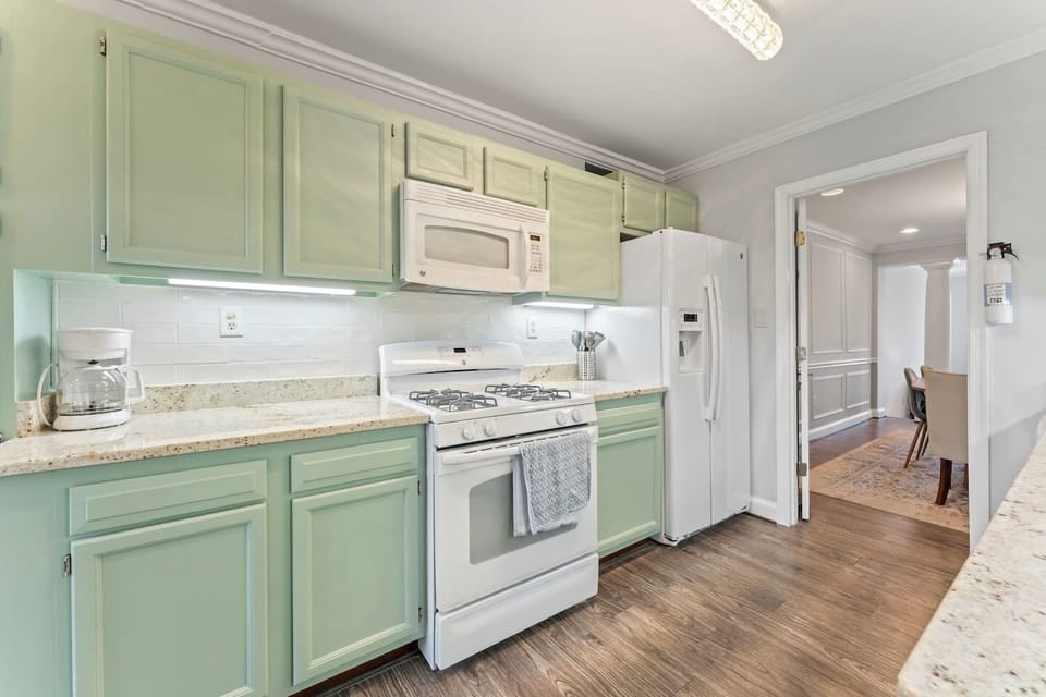 Full kitchen with gas range, microwave, and refrigerator—everything you need for home-cooked meals