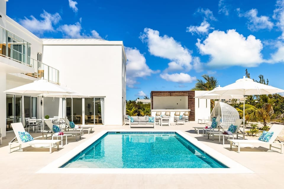 A modern, luxurious villa with a pool