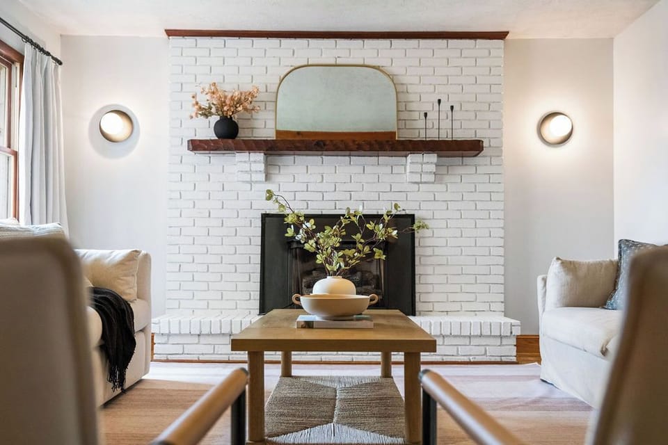 Cozy living room with warm minimalist decor and a non-functional fireplace.