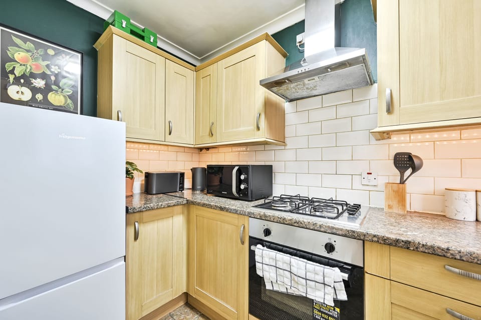 Kitchen with full-height fridge-freezer and generous worktop space