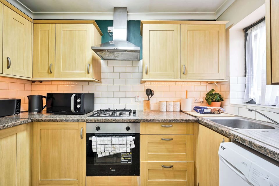 Spotlessly clean bathroom with basin, toilet and heated towel rail
