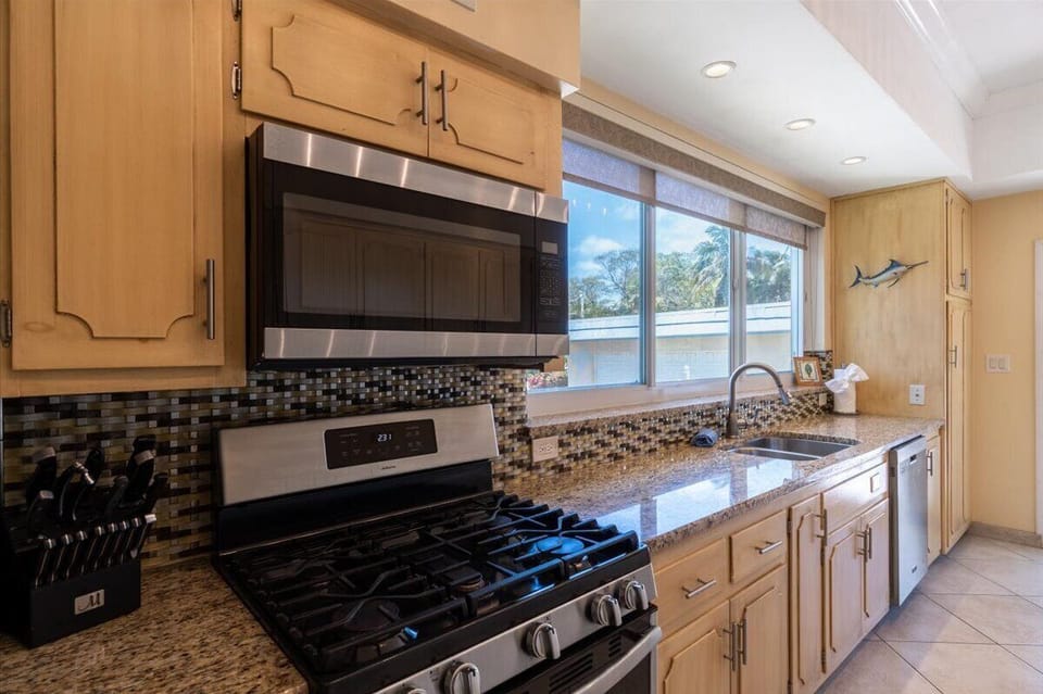 Ideal for families and anglers, this kitchen offers ample storage and prep space in a canal-front Marathon vacation property.