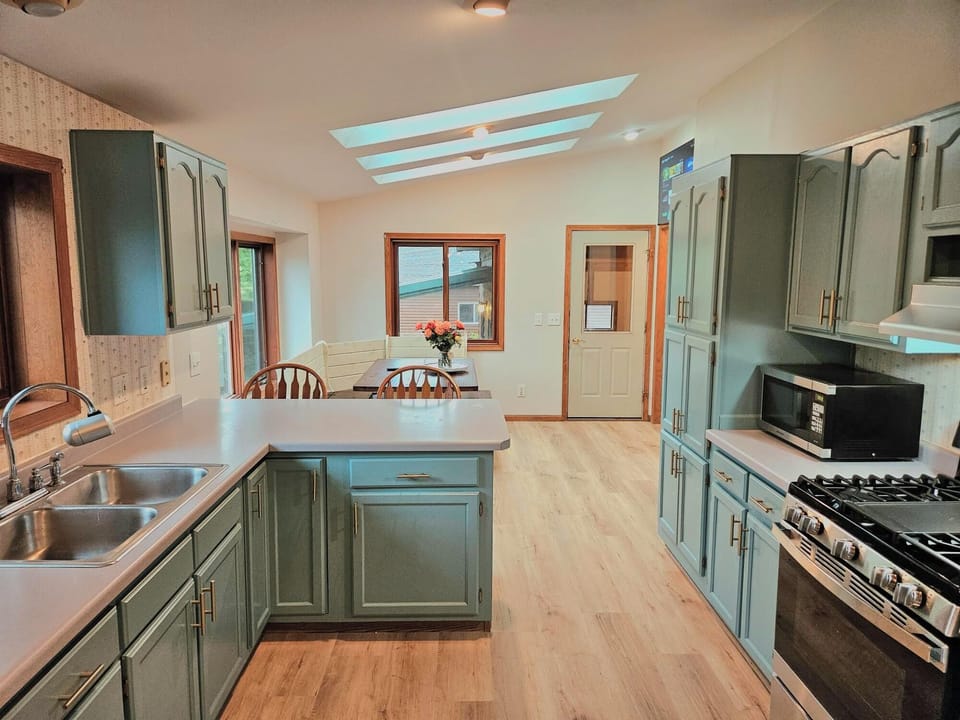 Large kitchen with several skylights for natural lighting