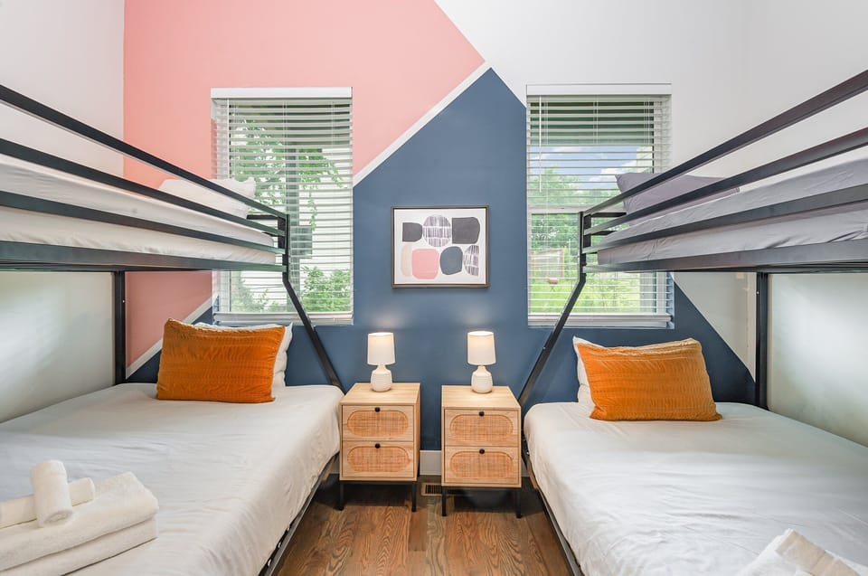 Unit 1: Fourth Bedroom invites fun and relaxation with two twin-over-full bunk beds, plush linens, and playful décor.