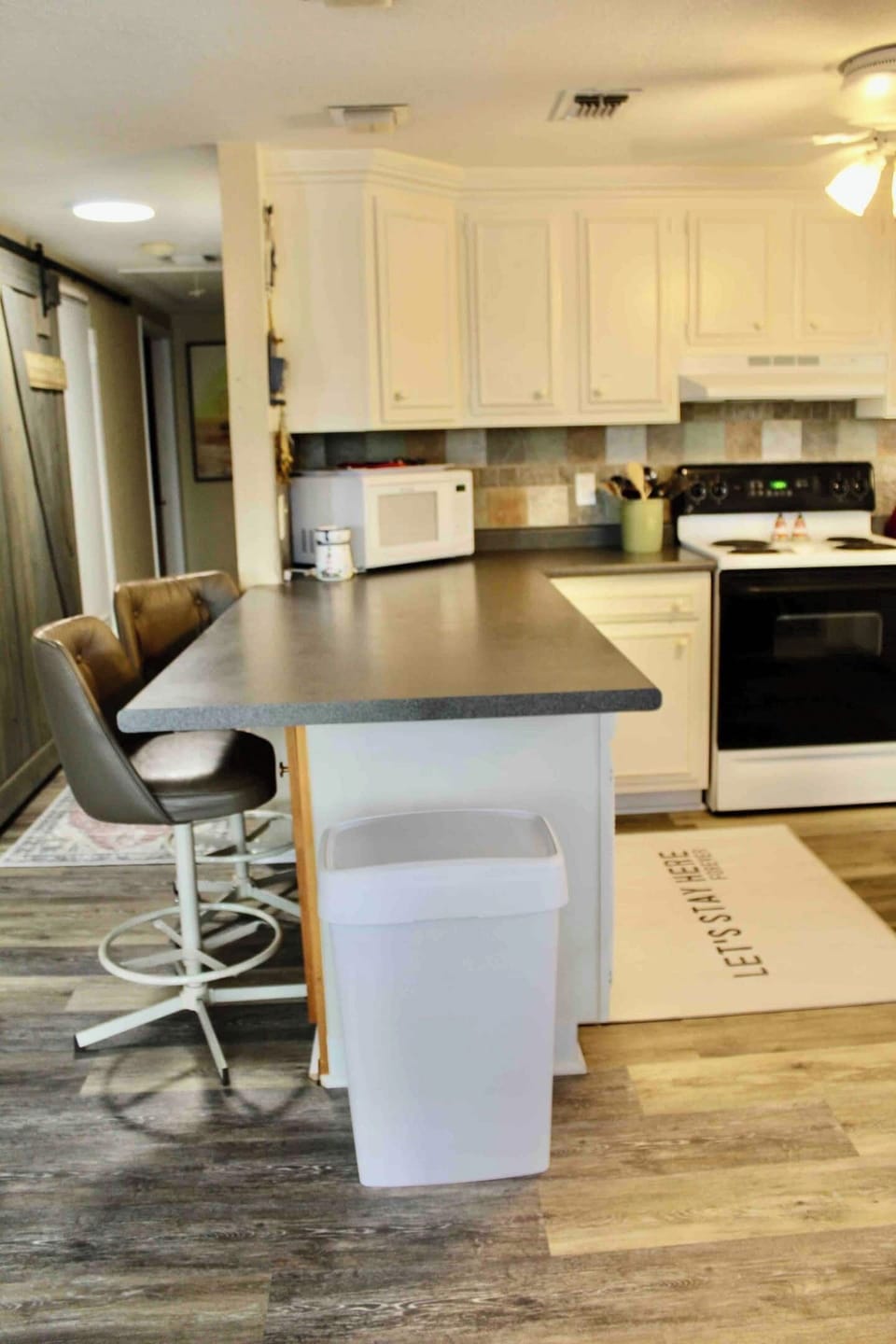 More seating at the island and a view of the side of the kitchen!