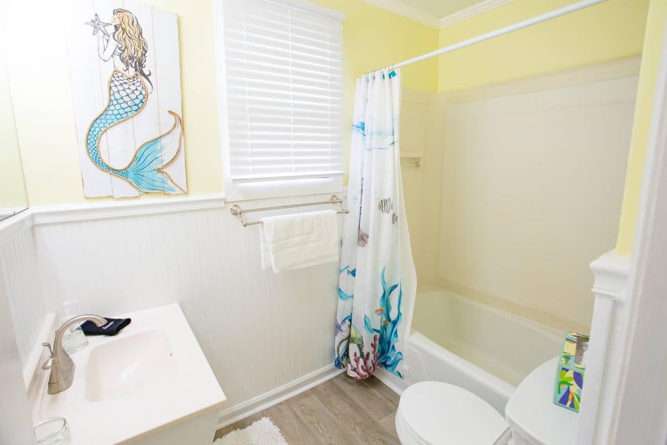 Lorraine's hall bathroom has a tub/shower combo