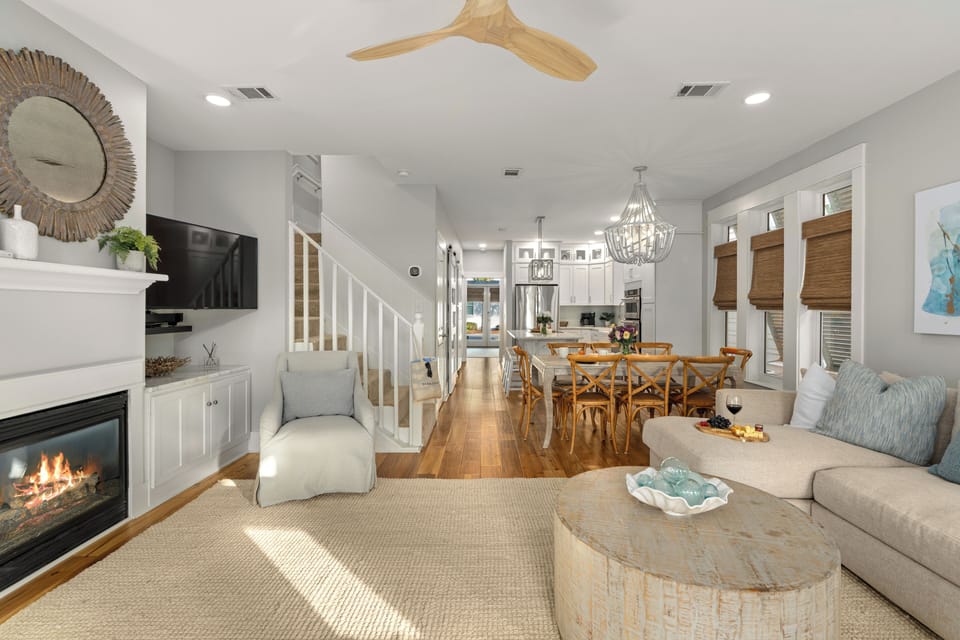 Wide view of the living room looking toward the dining area and kitchen.
