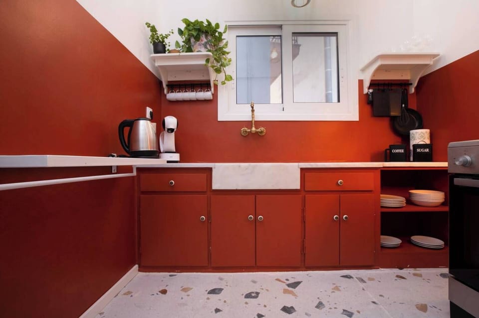 Charming farmhouse-style sink, open shelving, and earthy tones create an inspiring, functional kitchen environment for everyday meals.