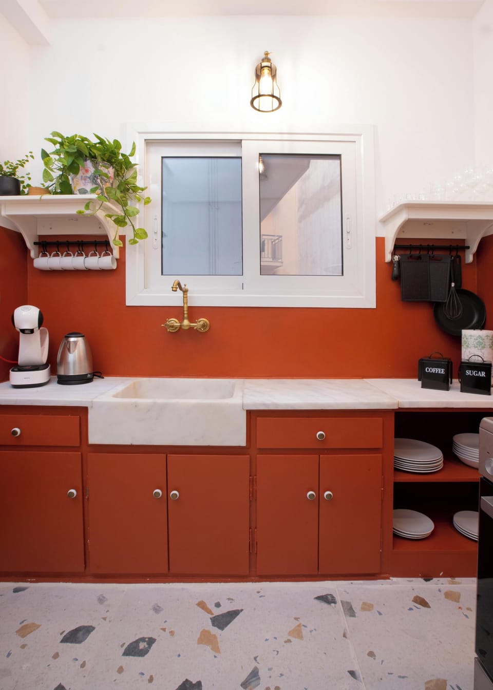 Bright kitchen with elegant brass fixtures, ample workspace, and organized shelving designed for smooth, effortless culinary routines.