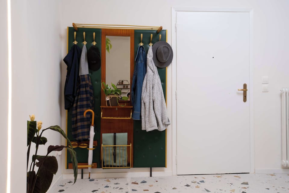 Welcoming entryway with stylish coat rack and mirror, creating an organized, charming first impression when arriving inside.