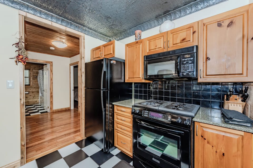 Fully equipped kitchen with warm wood finishes and modern appliances. Great for extended stays and self-catering at your country cottage.