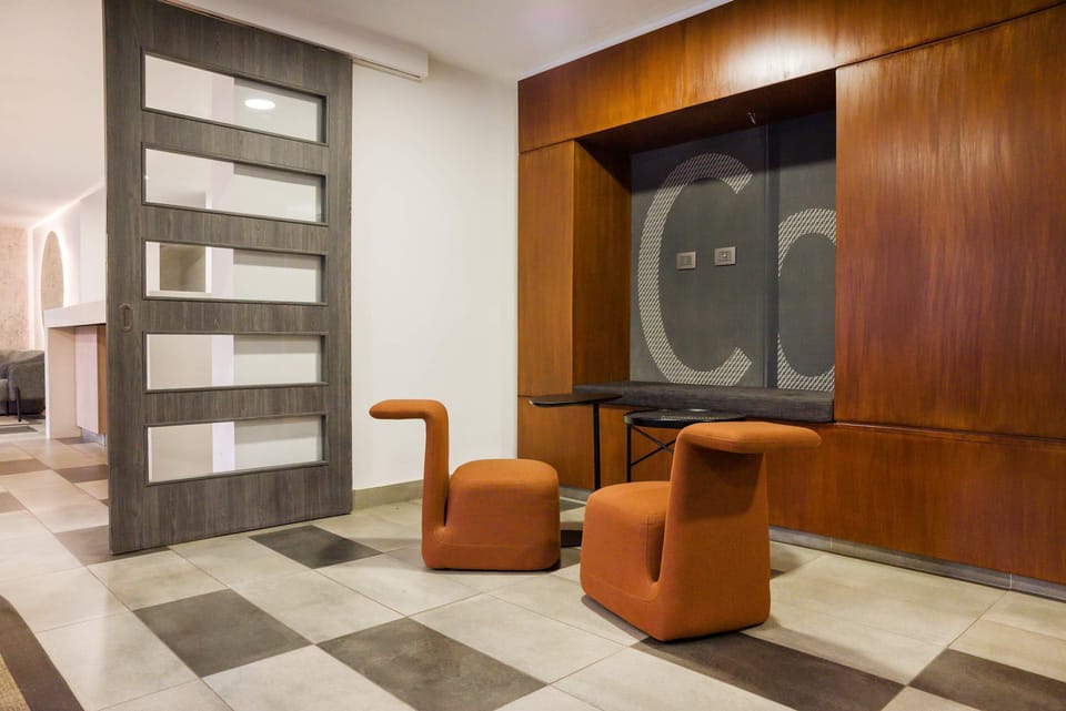 Discover a modern lounge with unique seating and stylish design elements. (Common Area)