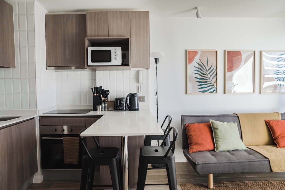 Modern kitchen with sleek appliances and cozy living area, perfect for relaxing after a day of exploring.