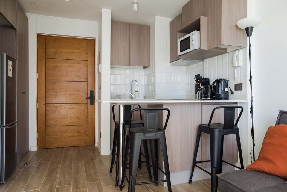Cozy kitchen with bar seating, perfect for quick meals and morning coffee in a stylish setting.