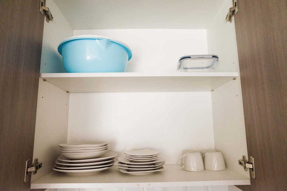 Organized kitchen cabinet with all essentials ready for your culinary adventures.