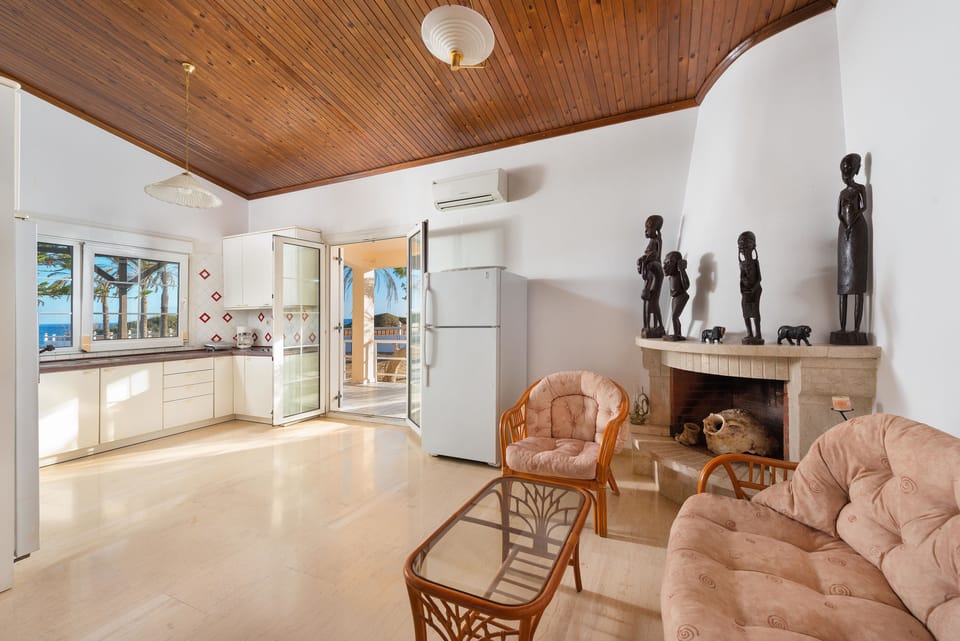 Villa, Sea View, Beachfront | Living area | Flat-screen TV