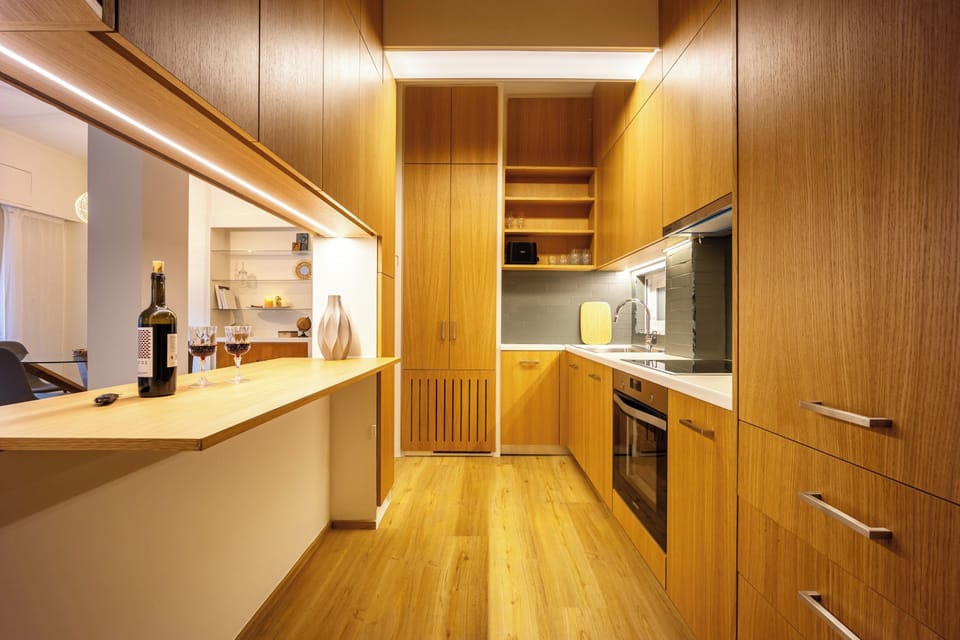 Warm wood cabinets and soft lighting create a welcoming cooking space.