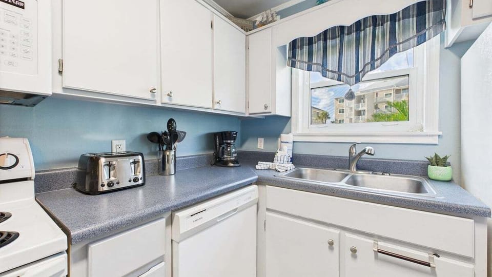 Kitchen equipped with coffee and microwave