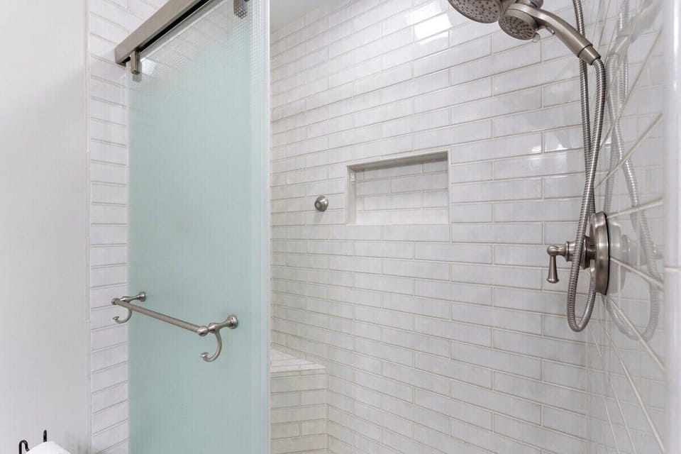 Master bathroom with dual vanity sinks and walk in shower