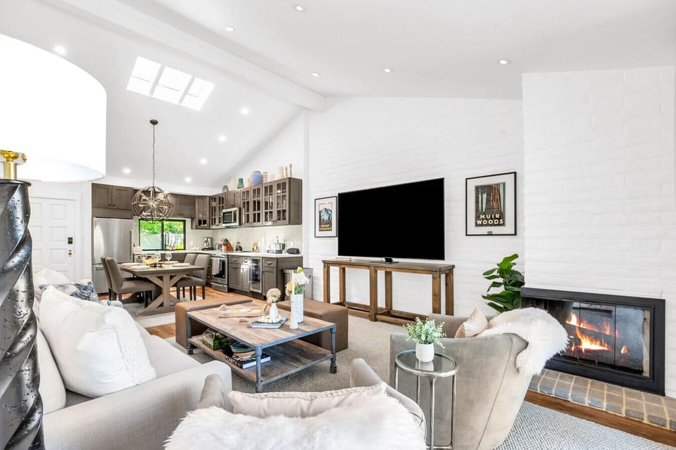 Open-concept comfort with cozy corners, warm firelight, and kitchen charm—this space has it all.
