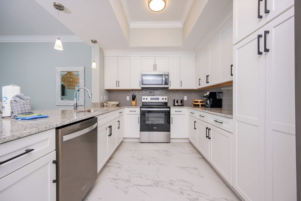 Prepare meals in this stylish kitchen featuring stainless appliances, ample counter space, and inviting decor