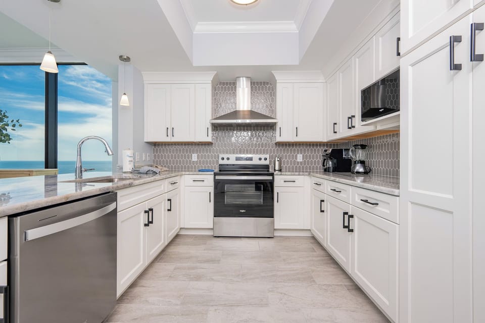 Prepare meals while enjoying breathtaking views of the beach in this stylish kitchen with stainless appliances