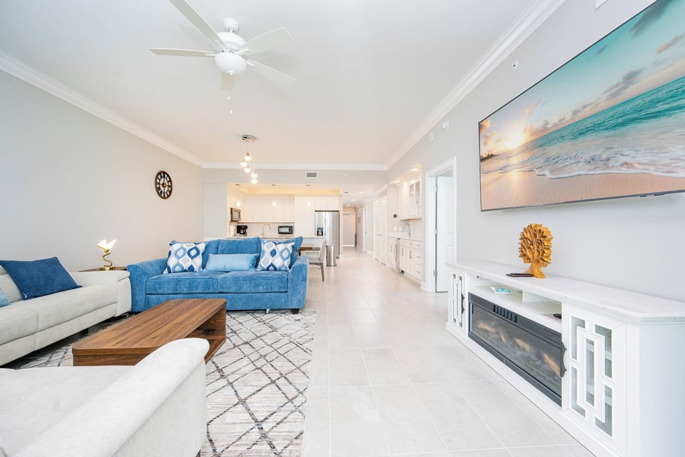 Relax on plush sofas in this inviting living area, complete with a large TV and a stylish coffee table for your comfort