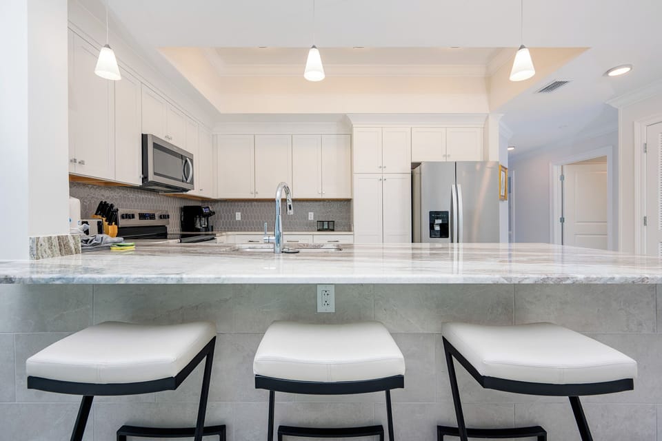 Gather around the stylish breakfast bar, perfect for morning coffee and casual conversation