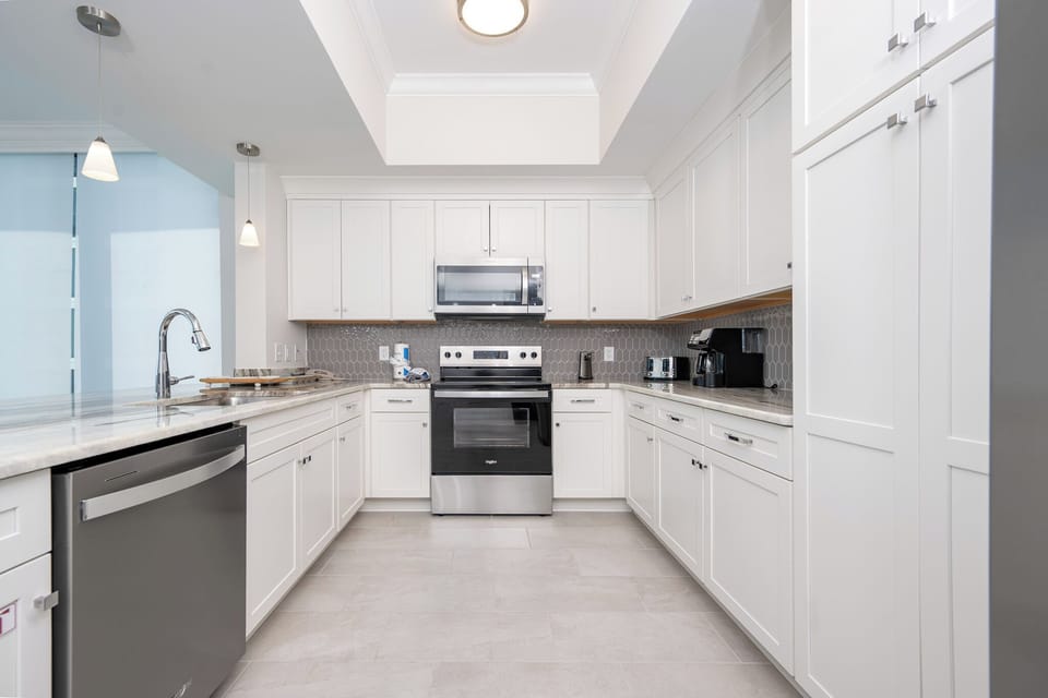Cook and gather in this kitchen, featuring stainless appliances and ample counter space for meal preparation