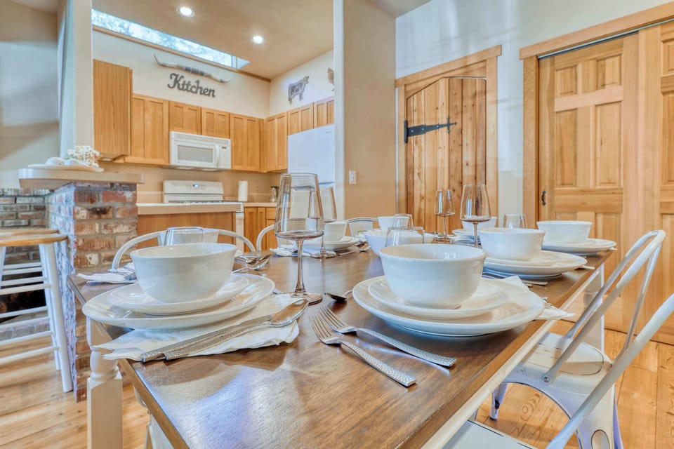 The sturdy wooden table is paired with matching chairs, styled to reflect the ranch's rustic charm. Perfect for large family meals or game nights.