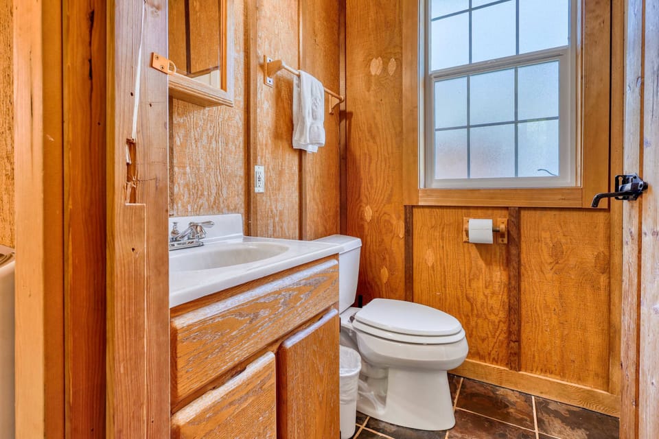 Charming Bathroom: Bright space with wood accents, perfect for refreshing or unwinding after adventures!