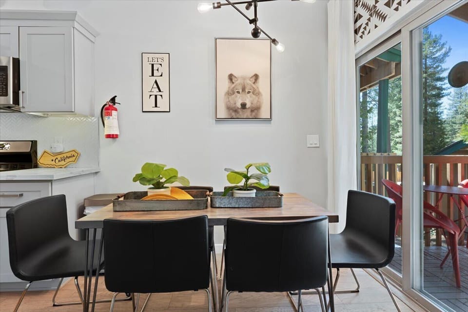 A cozy dining space with black chairs, natural light, and easy access to the modern kitchen. 🥞