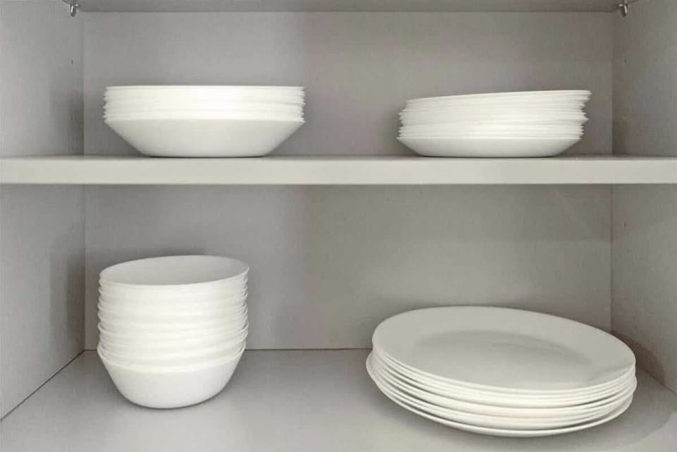 Open shelving with neatly stacked plates and bowls, ready for any meal you prepare. 🍽️