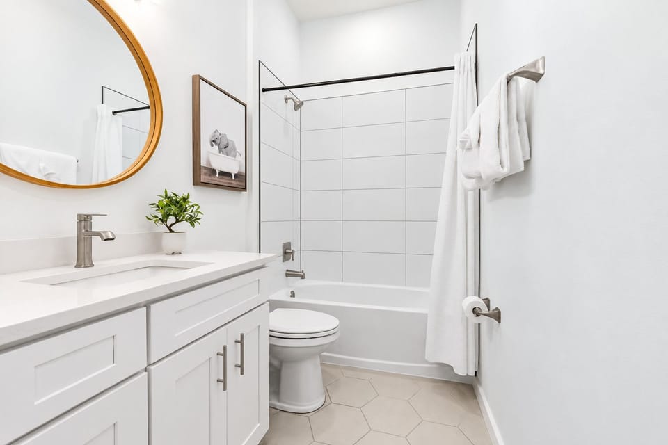 Bright modern bathroom with tub-shower combo and stylish finishes