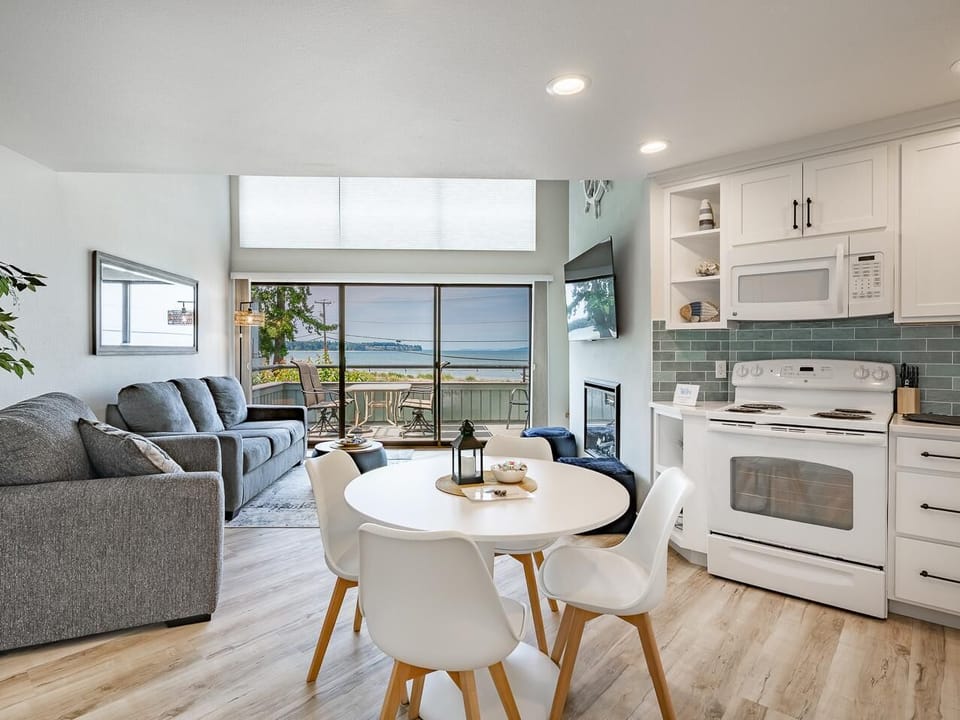 Bright open kitchen and living room with scenic water views