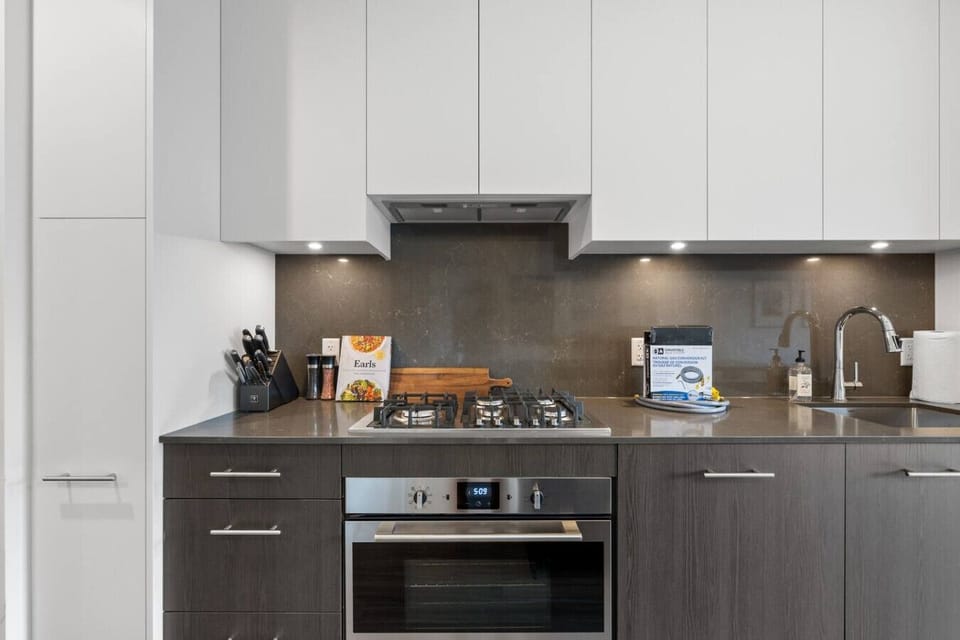 Full kitchen with a drip coffee maker, ground coffee, tea & sugar.