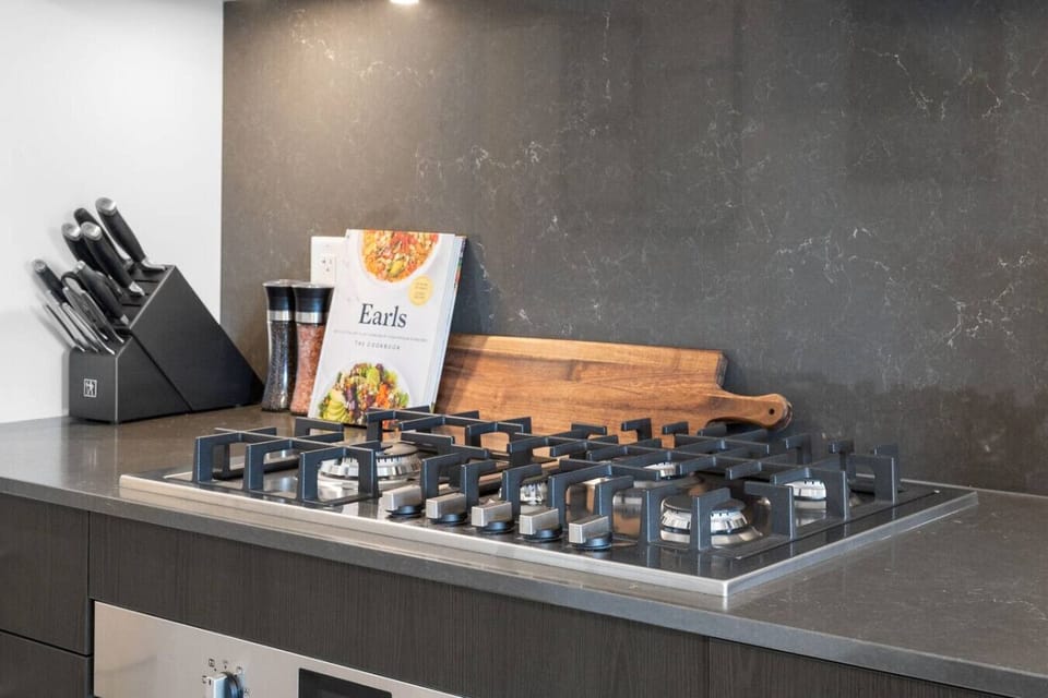 Full kitchen with a drip coffee maker, ground coffee, tea & sugar.