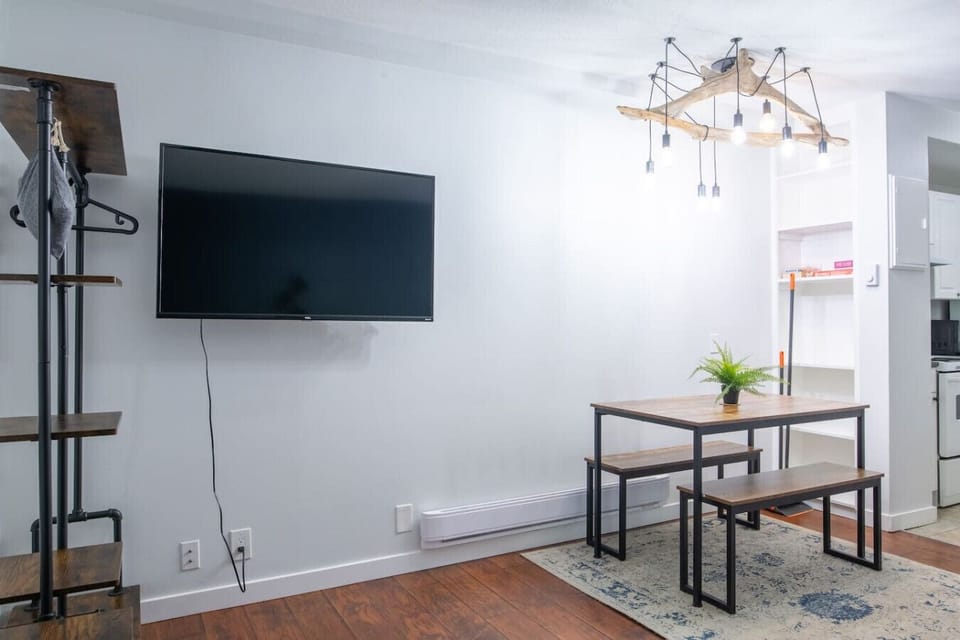 Relaxing main area with a smart TV and dining table.