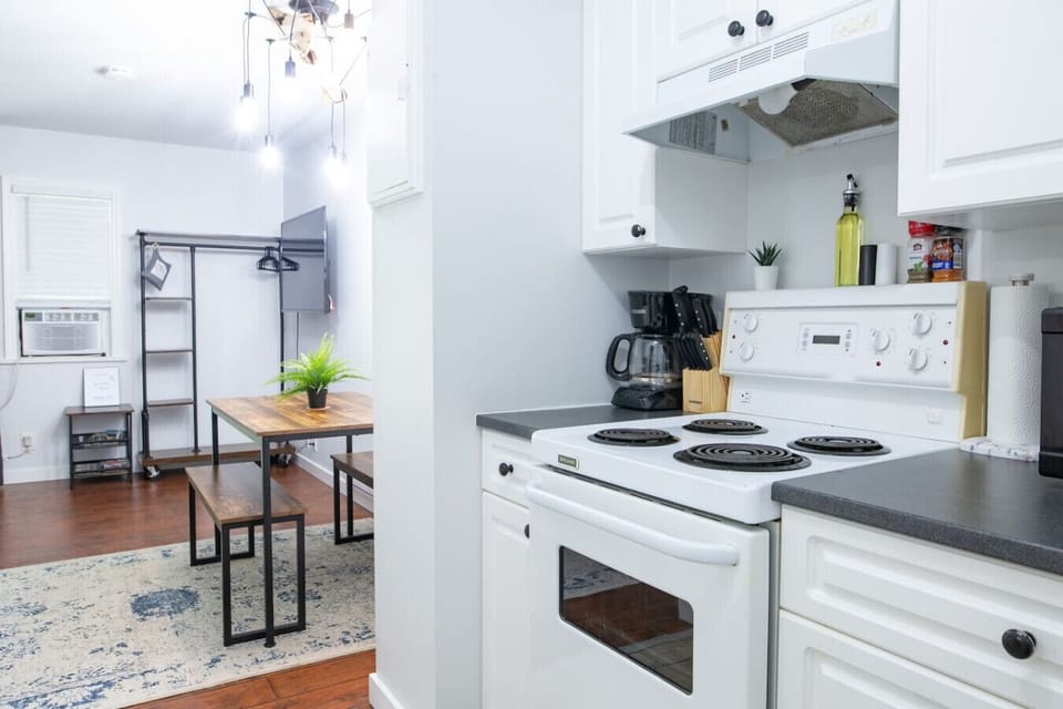 Fully equipped kitchen leads into the main area.