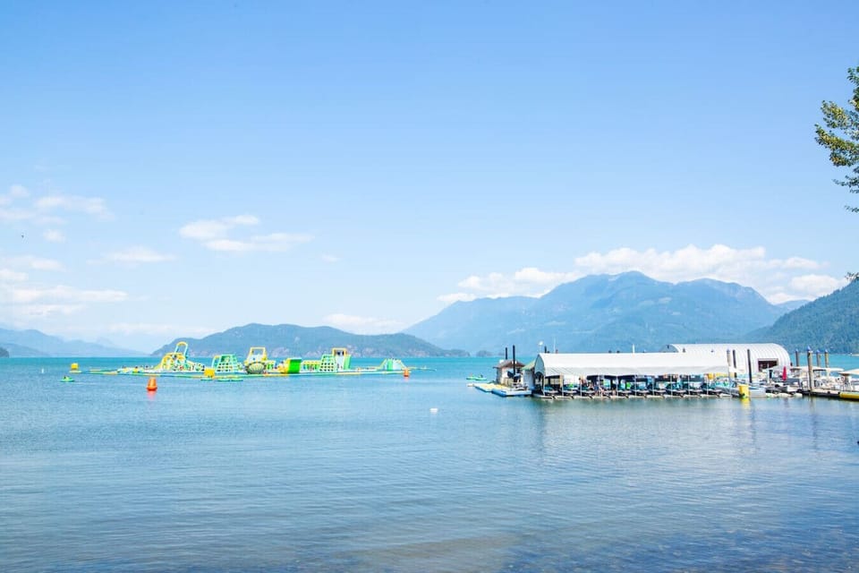 Family-friendly beach area with bouncy waterpark and playground nearby.
