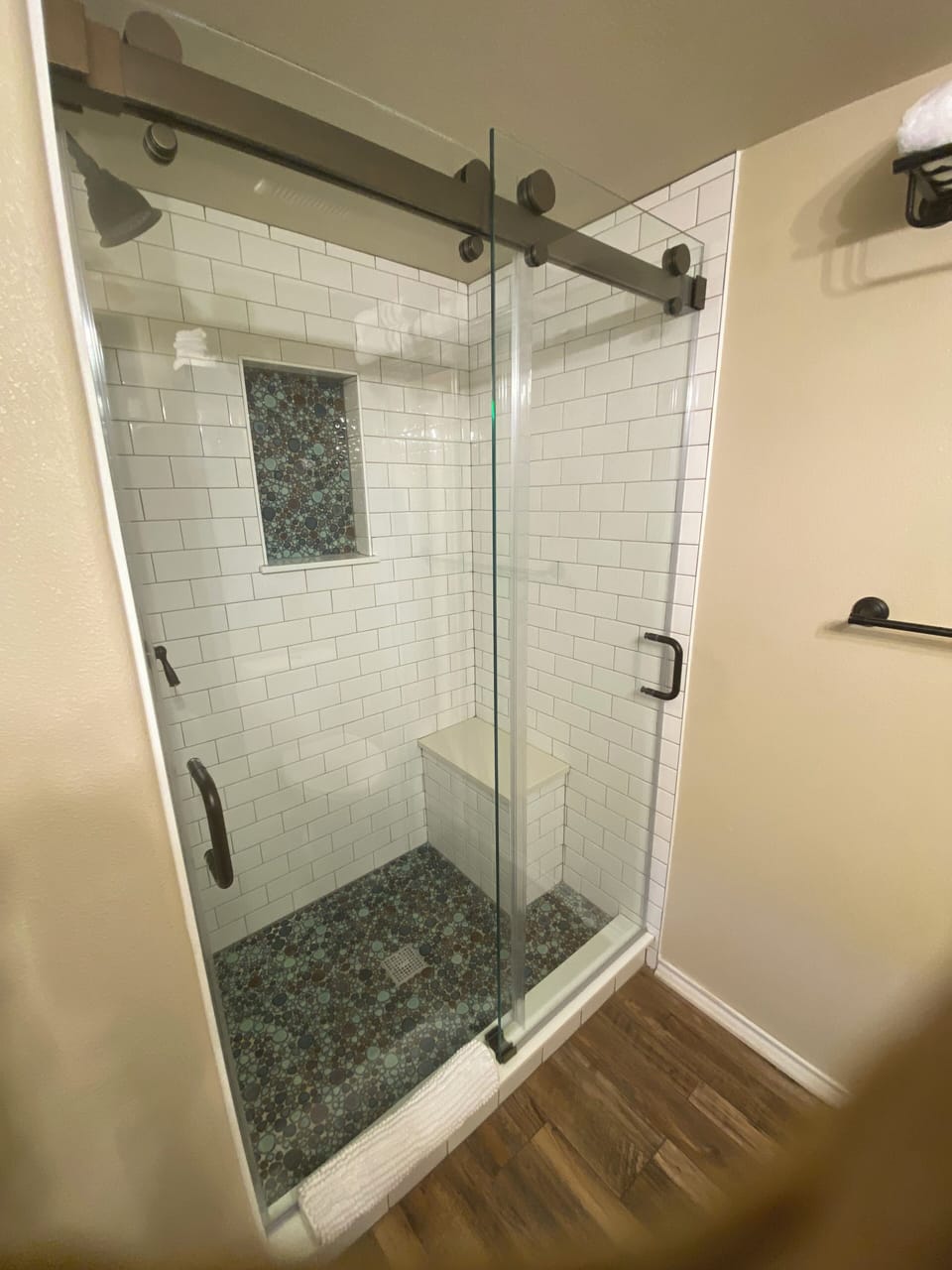 Full bathroom with walk-in tile, shower and seating bench