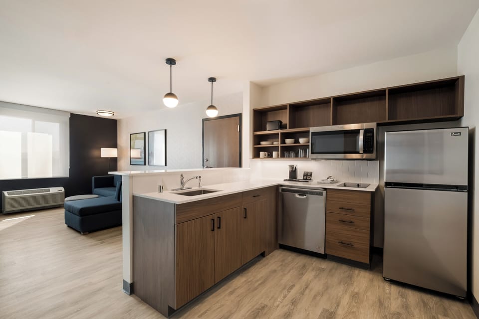 Suite, 1 King Bed, Non Smoking | Desk, laptop workspace, blackout drapes, iron/ironing board
