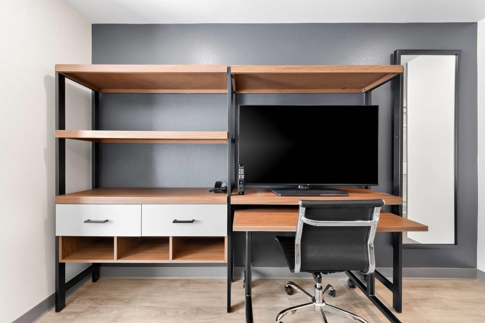 Suite, 1 King Bed, Non Smoking | Desk, laptop workspace, blackout drapes, iron/ironing board