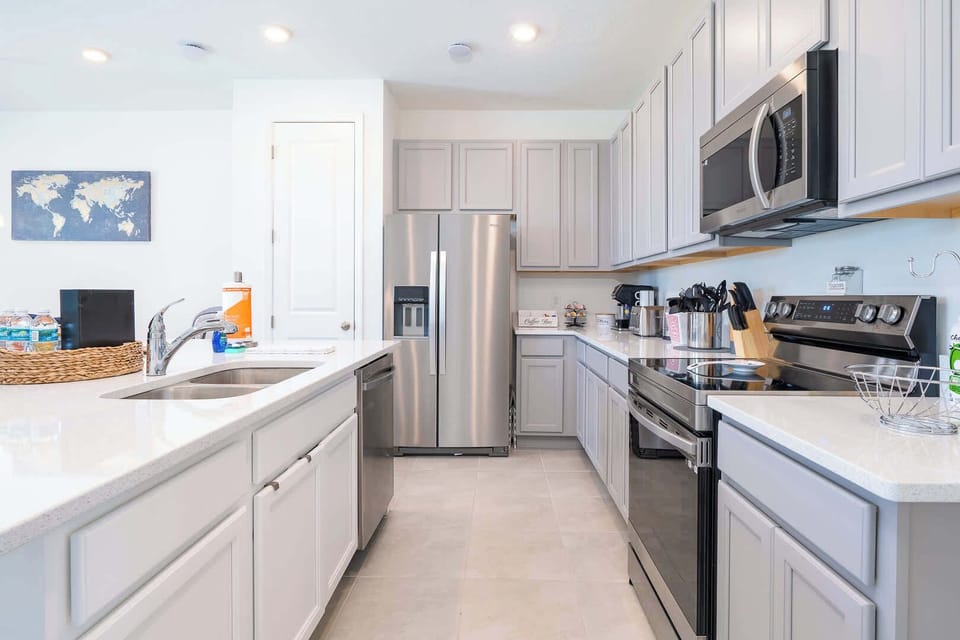 The sleek kitchen offers loads of space & all the comforts of home